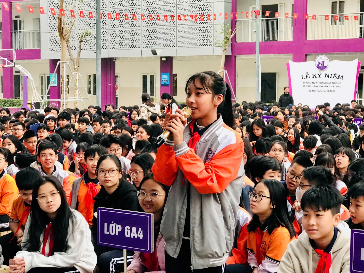 A child holding a trumpet in front of a crowd of people

Description automatically generated